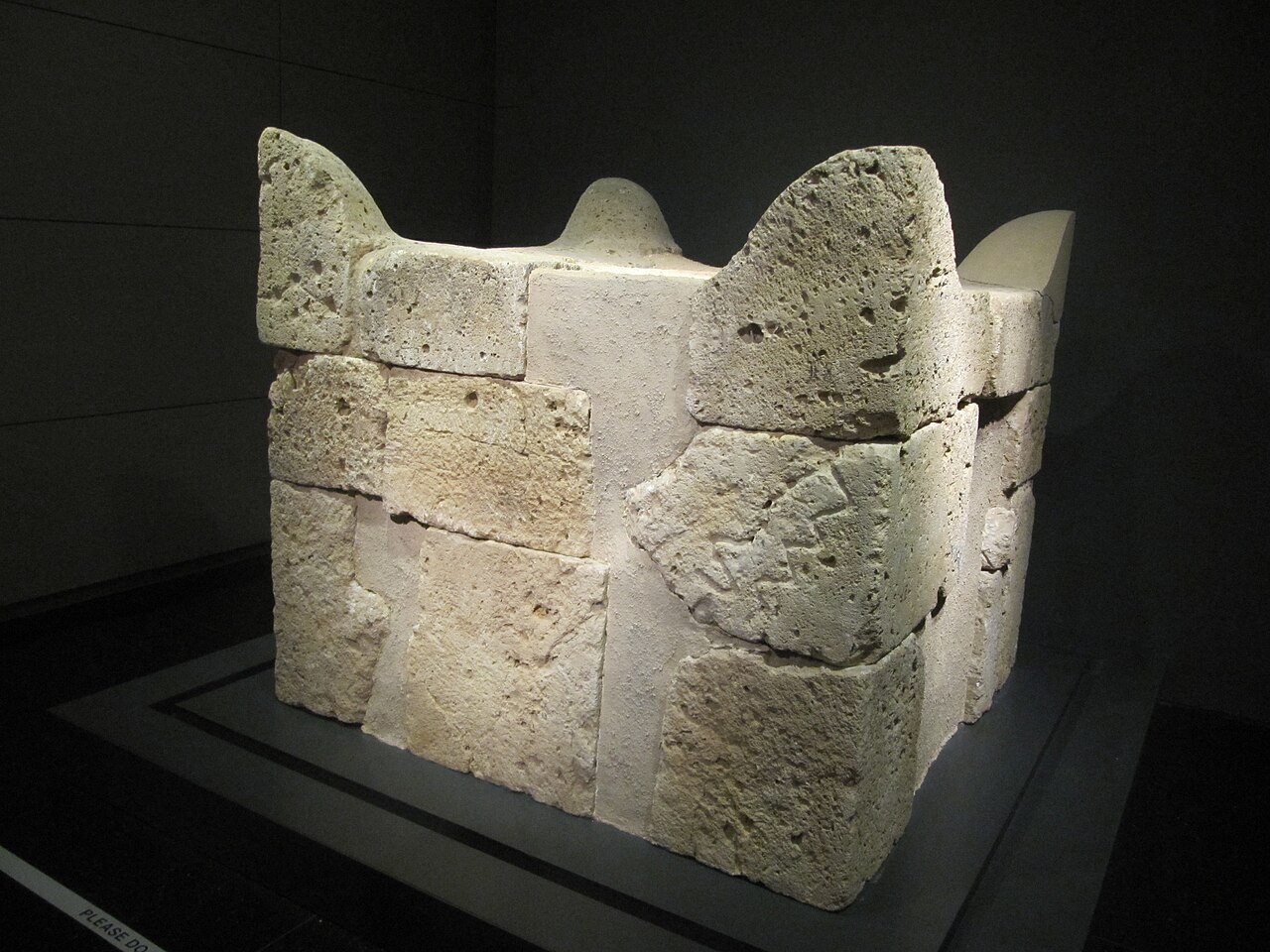 The reconstructed horned altar from Tel Beersheba at the Israel Museum — a squat square altar of smooth ashlar blocks with four projecting horns at its corners.
