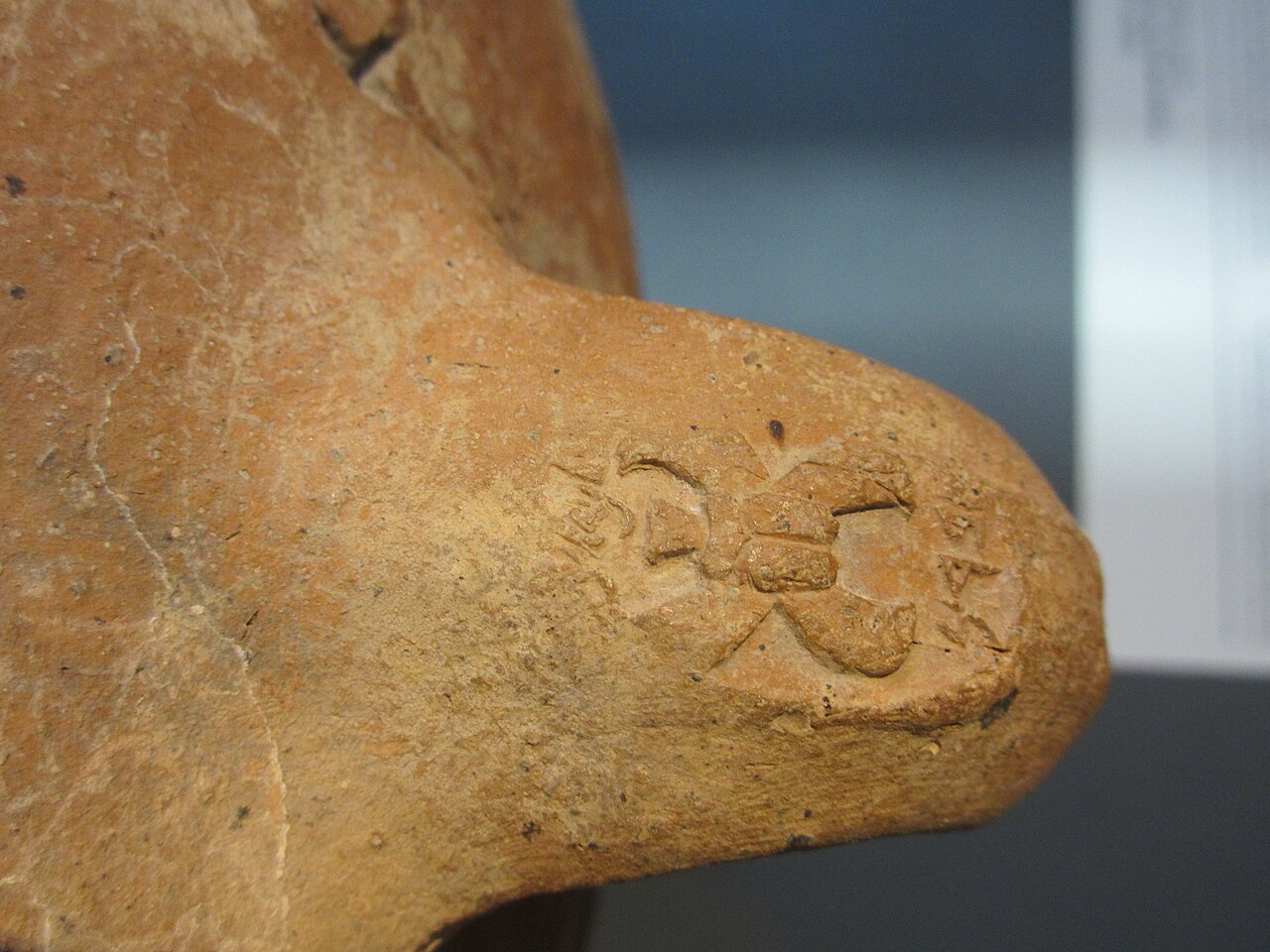 A storage-jar handle in the Israel Museum stamped with a winged lmlk seal impression naming Chevron.
