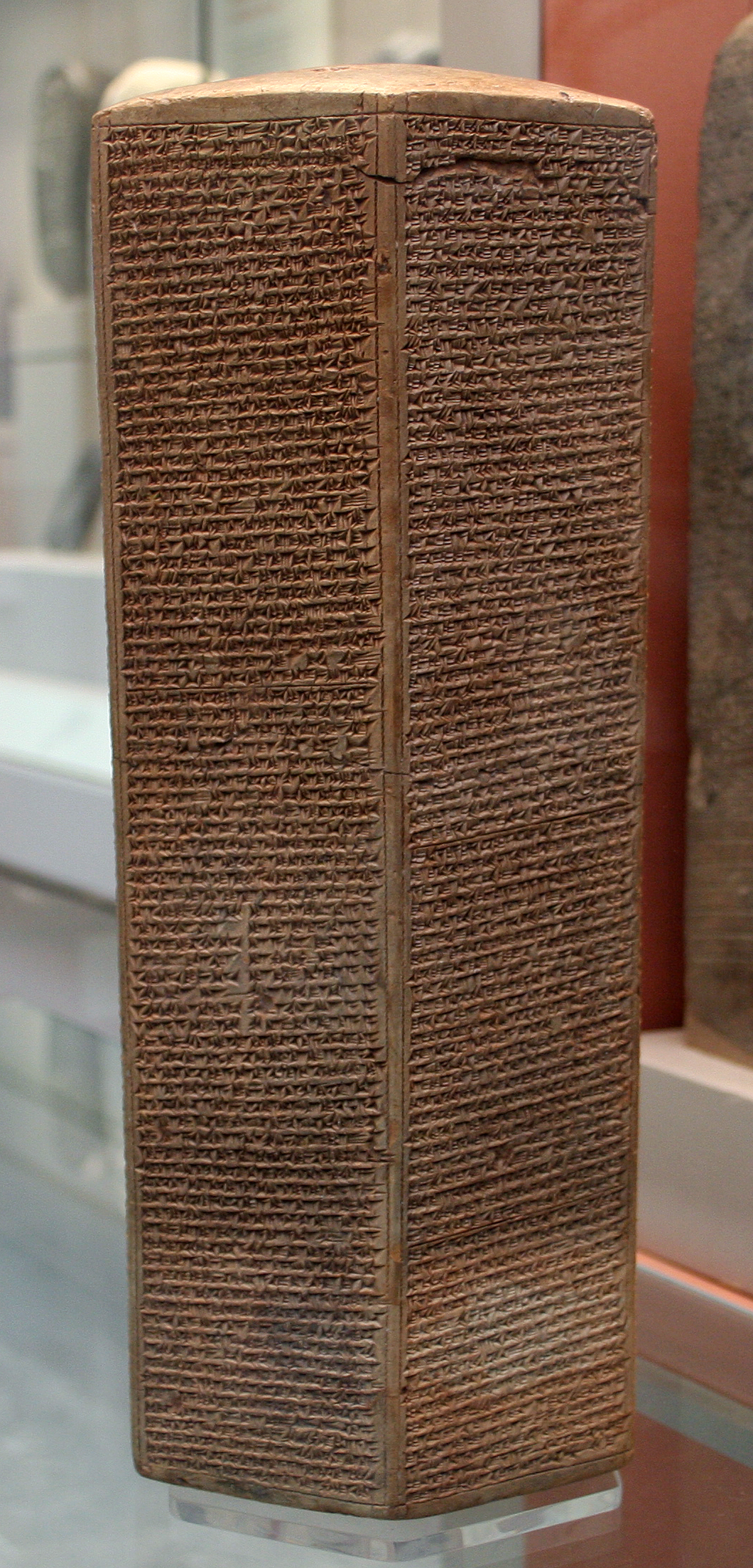 The Taylor Prism in the British Museum — a tall six-sided prism of baked clay, every face covered in dense lines of cuneiform.
