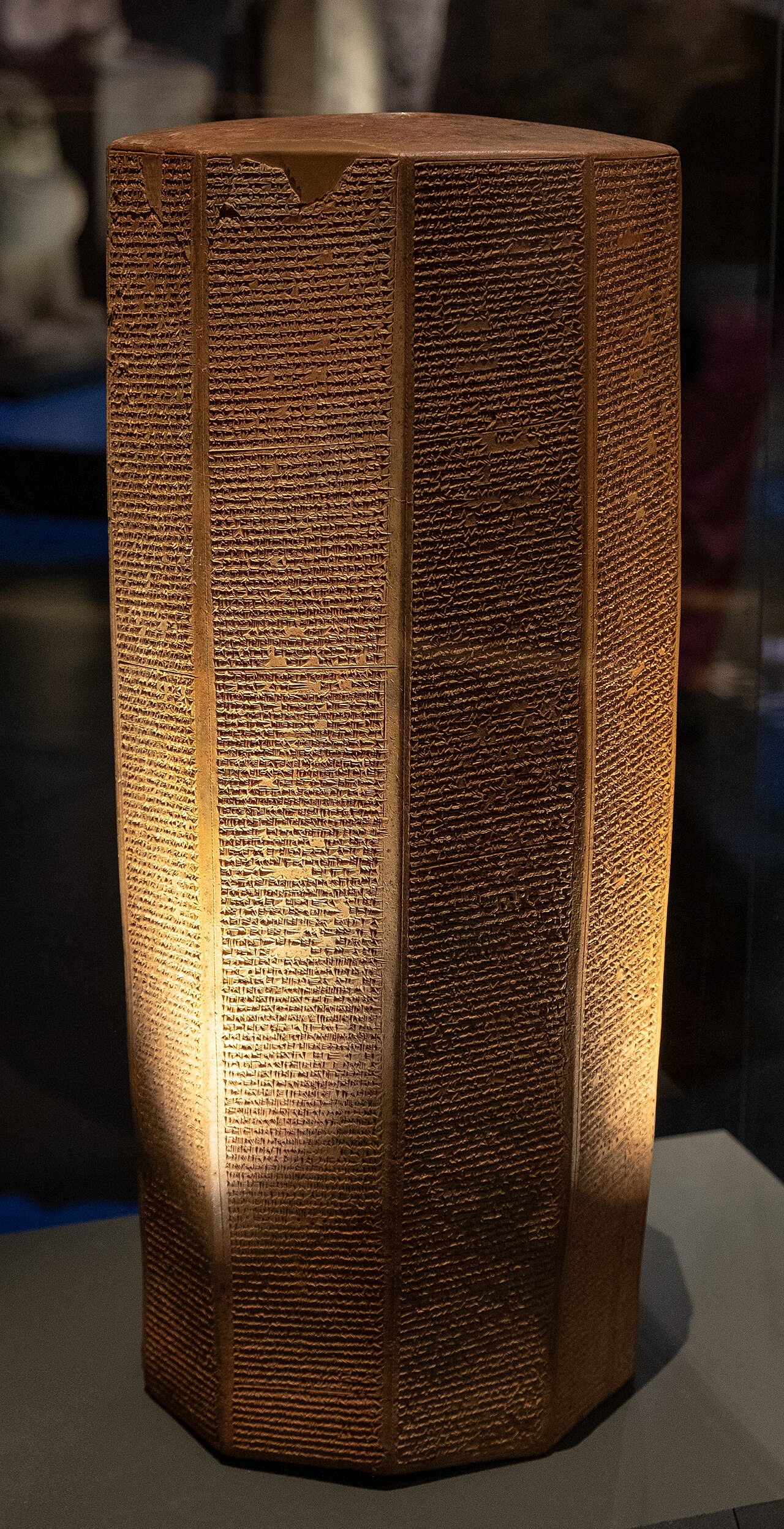 The Rassam Cylinder of Ashurbanipal in the British Museum — a ten-sided baked-clay prism covered in minute cuneiform columns.
