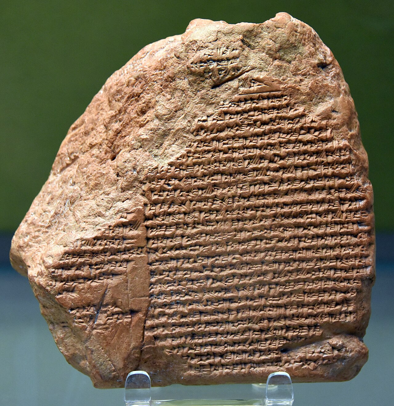 The Nabonidus Chronicle in the British Museum — a squat clay tablet, corners broken away, its face covered in close-set cuneiform lines.

