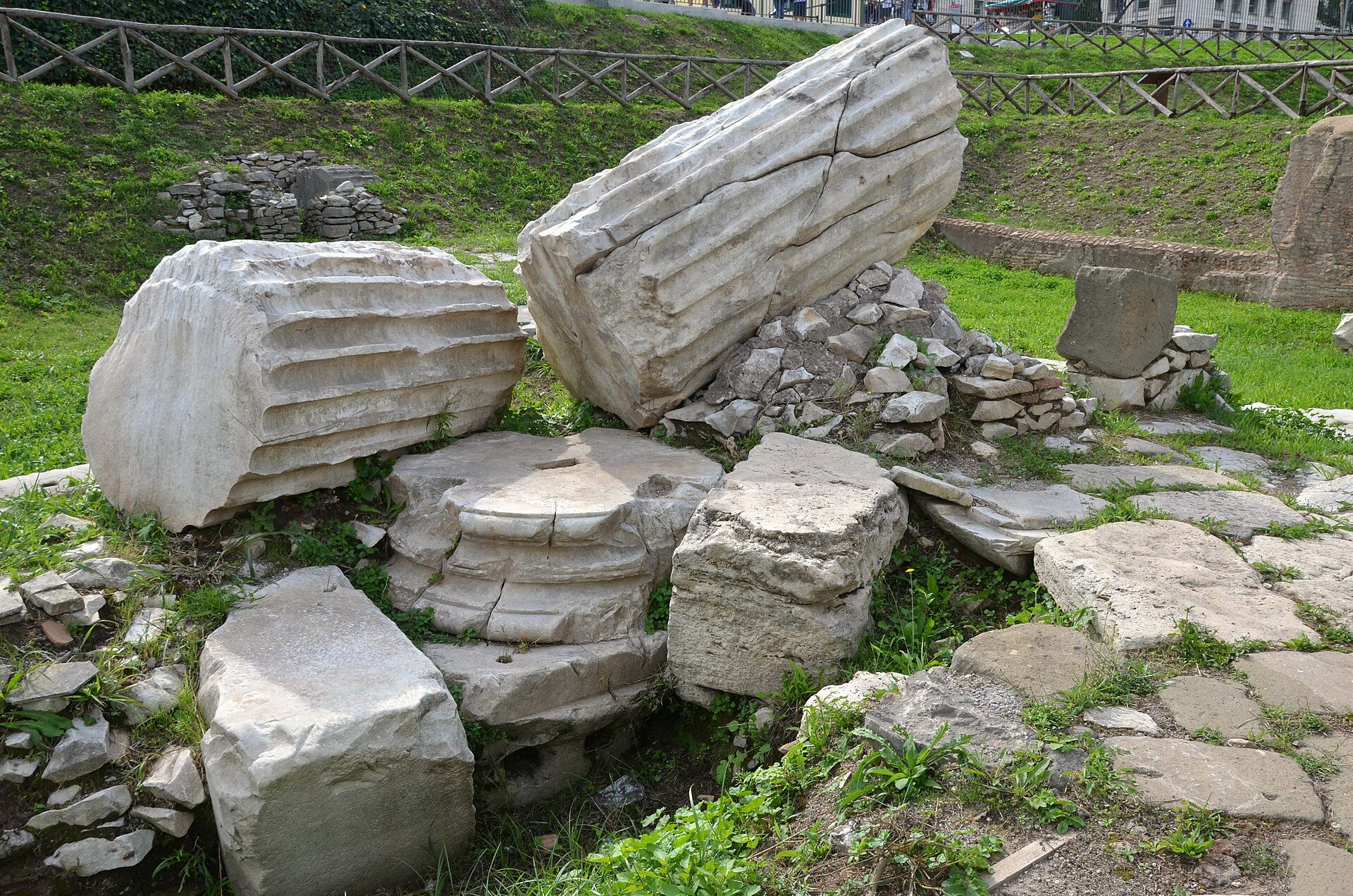 Broken fluted column drums and marble fragments of the lost Arch of Titus, unearthed in 2015 at the eastern end of the Circus Maximus in Rome, laid out at the excavation site.
