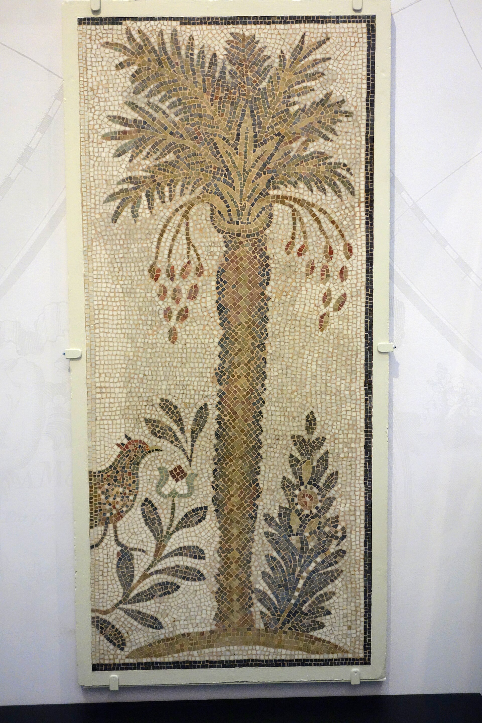 Mosaic panel of a date palm from the Hammam Lif synagogue, in the Brooklyn Museum — a stylized fruiting palm tree in colored tesserae.